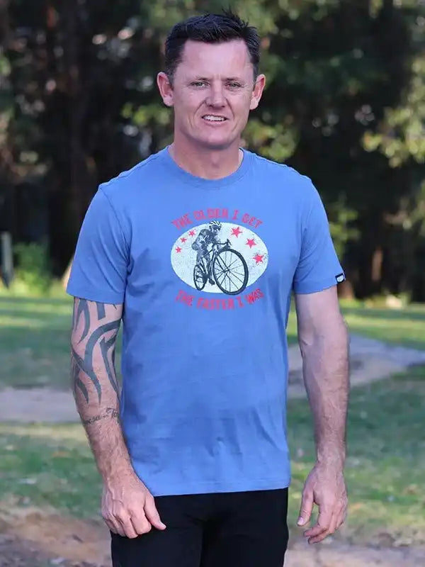 Man wearing blue cycling graphic tee with cyclist design, ideal for men's bike apparel