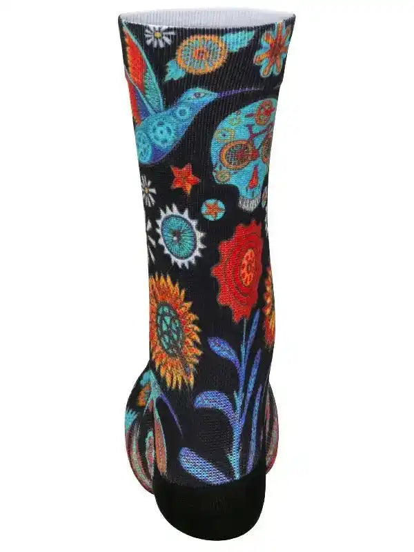 Colorful cycling sock with hummingbird, flowers, and sugar skull design on black background