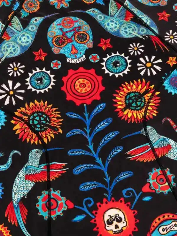 Vibrant cycling jersey with hummingbirds, skulls, and sunflowers on black fabric