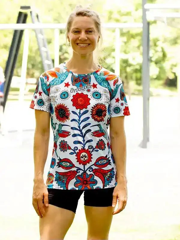 Woman wearing colorful floral cycling jersey with unique design, perfect for bike rides and outdoor adventures.