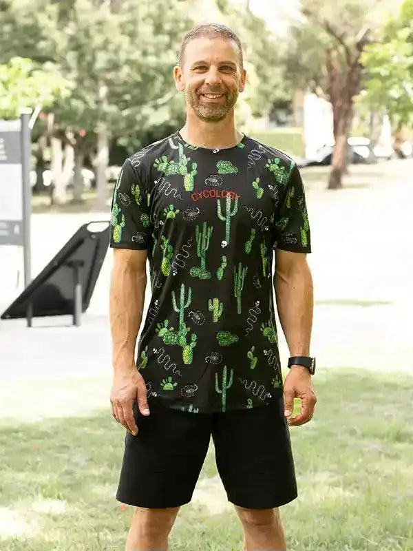Man wearing black cactus-print cycling jersey and shorts outdoors