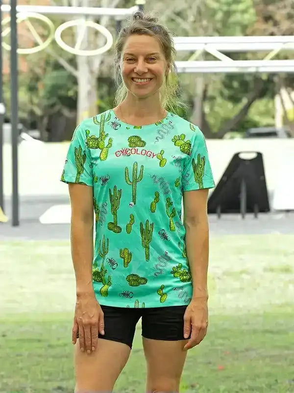 Woman in green cactus-print cycling jersey and black shorts, outdoor active wear