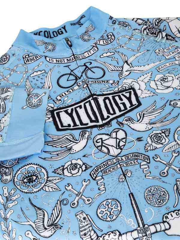 Light blue cycling jersey with tattoo-style graphics, birds, roses, and 'Cycology' logo for men's and women's bike wear