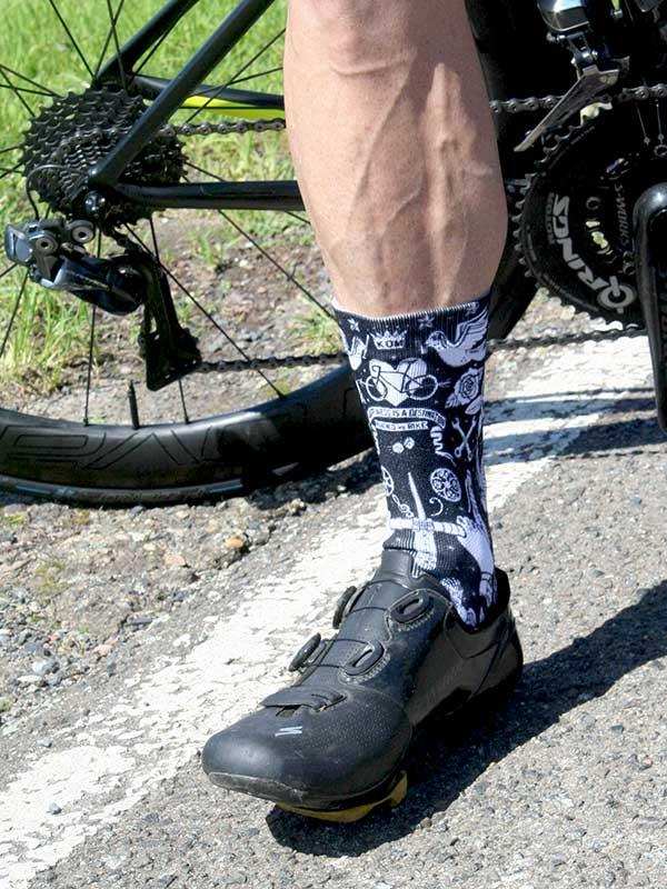 Cycling socks with bike graphics, worn with black cycling shoes and bike gear outdoors