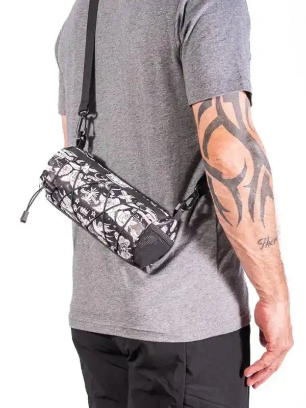 Cycling waist bag with floral pattern, worn by man with tattooed arm, ideal for bike rides