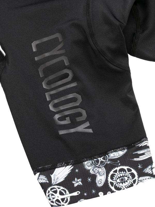 Black cycling jersey with 'CYCOLOGY' text and gear/butterfly print hem, men's or women's bike wear