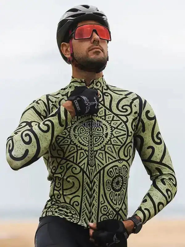 Man in patterned cycling jersey, helmet, and red-tinted sunglasses outdoors